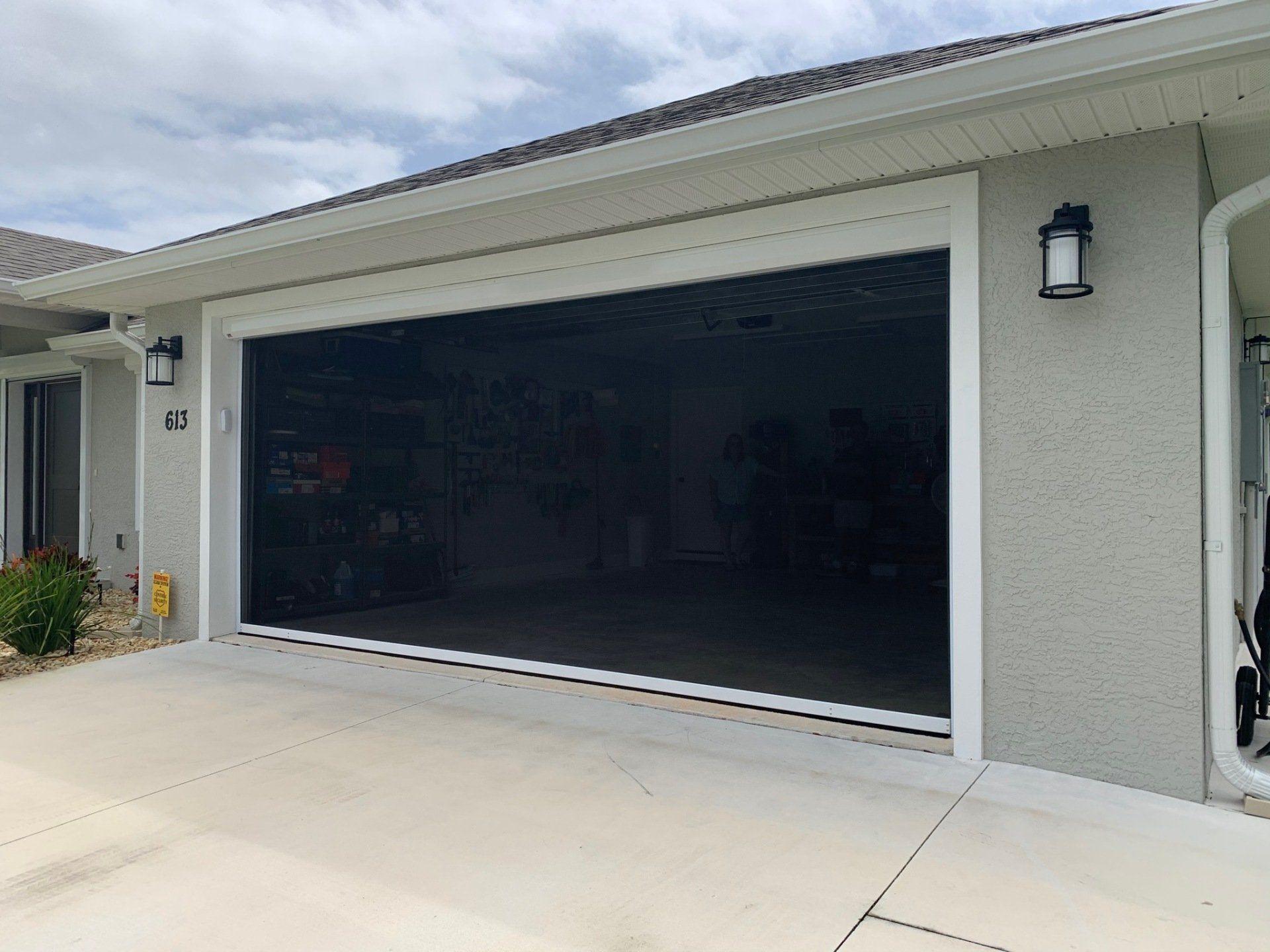 Motorized garage screen mechanism and housing
